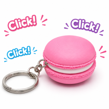 Pink macaron clicker keychain with silver keyring and "Click!" text.