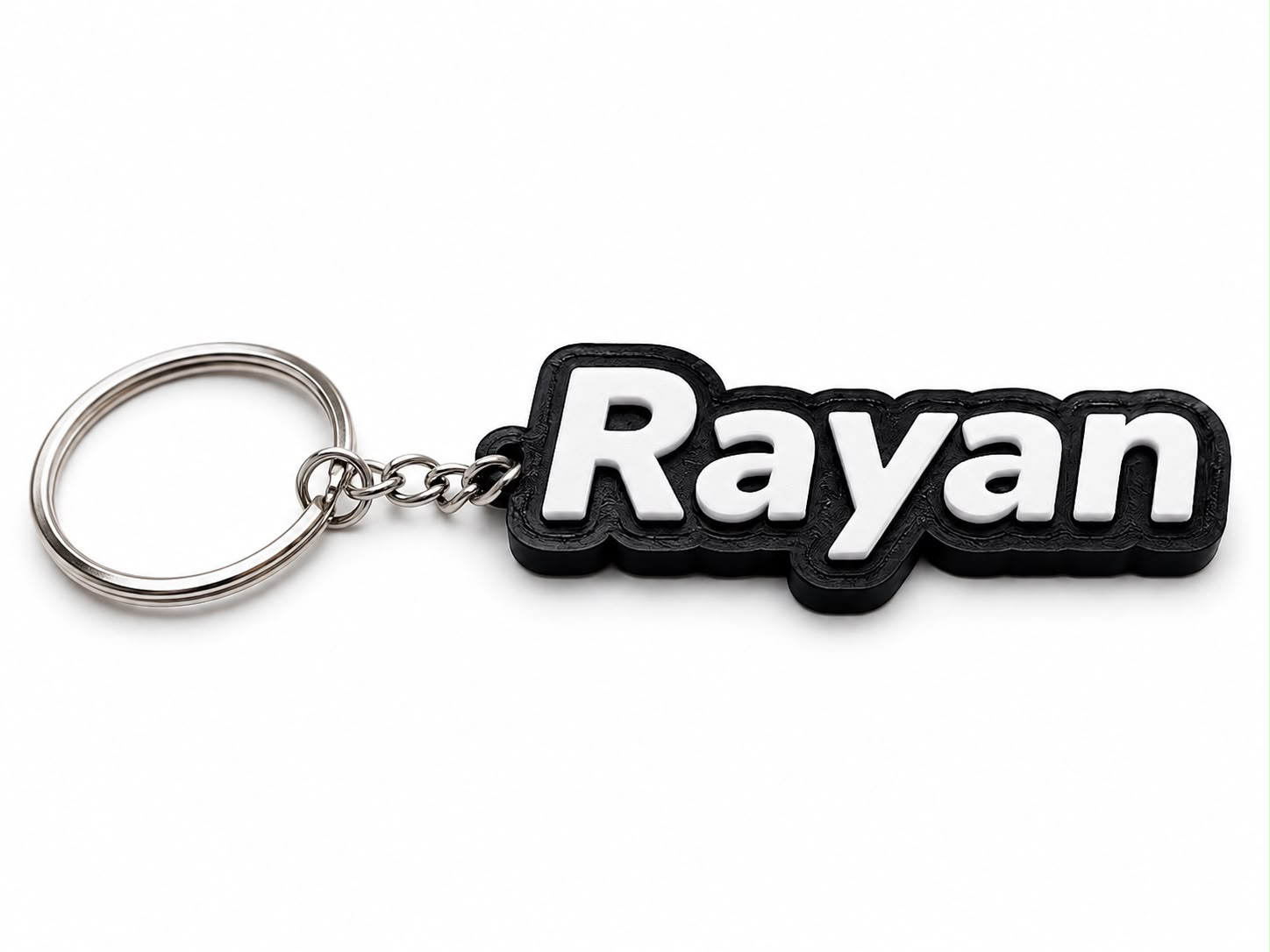 Personalized 3D printed name keychain with "Rayyan" in bold black letters and a silver keyring.