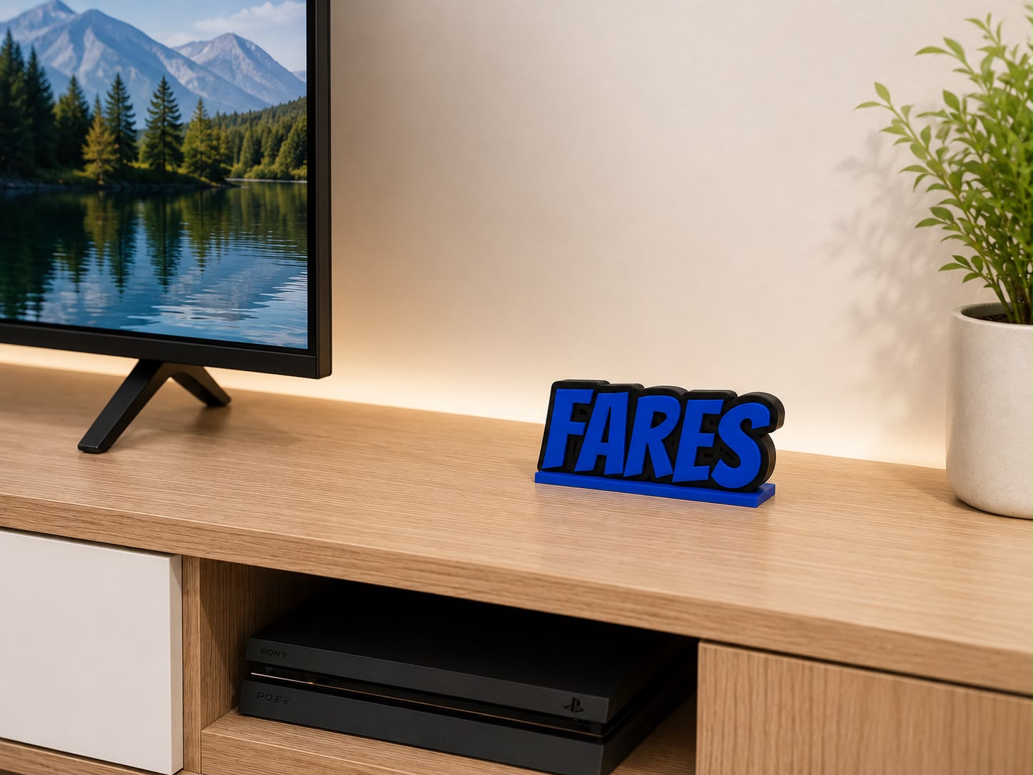 Personalized 3D desk name sign "Fares" on a gaming setup with a TV and PlayStation.