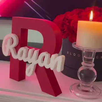 Personalized baby birth sign with name "Rayyan" and decorative candle, made in Dubai.