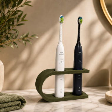White and black electric toothbrushes in a 3D-printed travel case.