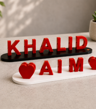 Personalized name boards and baby birth signs with red lettering and heart accents, designed and