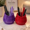 Forjolie 3D-printed pen holders in purple and red holding black pens on a desk