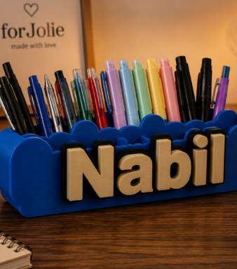 Personalized name pen holder with 3D printed desk sign and colorful pens.