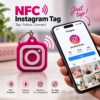 Pink Instagram-shaped NFC tag keychain tapping a phone to instantly open an Instagram profile - Forjolie.dxb