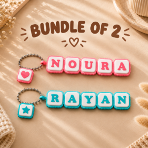 Forjolie bundle of 2 personalized name keychains spelling Noura and Rayan in pastel letter tiles with a heart charm