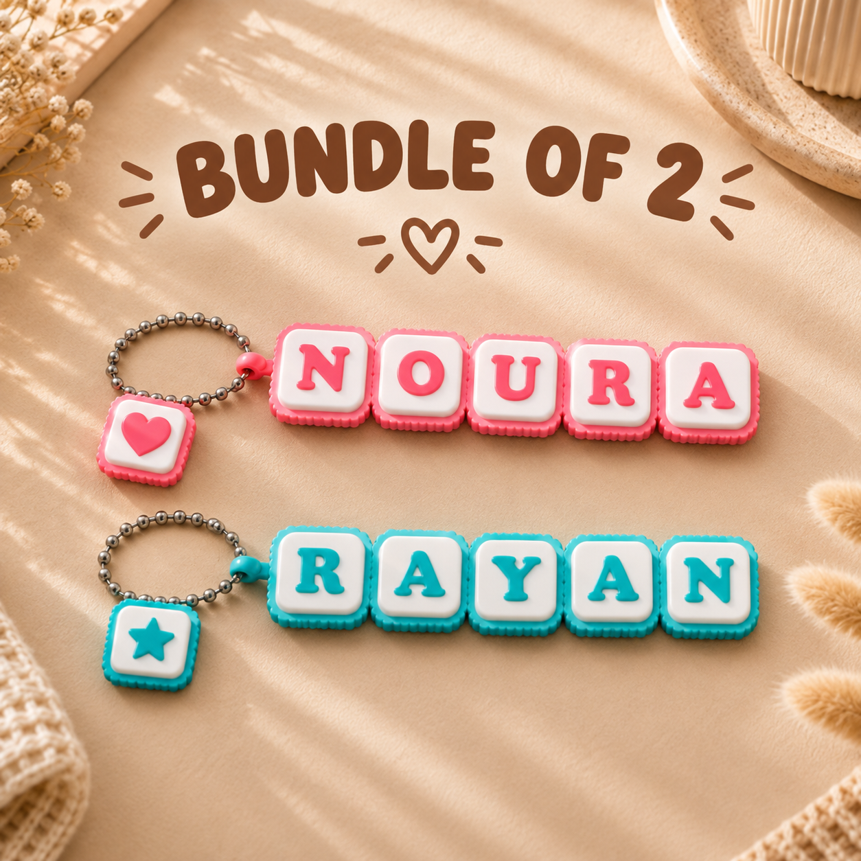 Forjolie bundle of 2 personalized name keychains spelling Noura and Rayan in pastel letter tiles with a heart charm