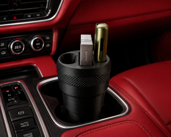 3D printed IQOS car holder in a vehicle's cup holder, showcasing compartments for the device